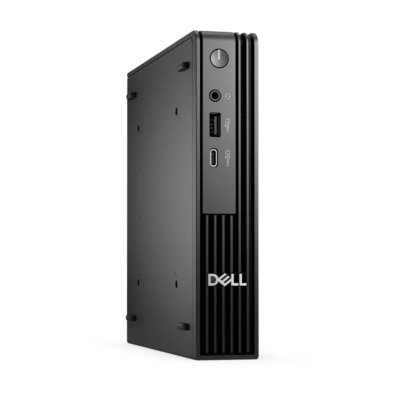 Vista lateral izquierda frontal del QCM1250 en vertical, mostrando perfil compacto, teclado Dell KB216 ESP y mouse Dell MS116 incluidos